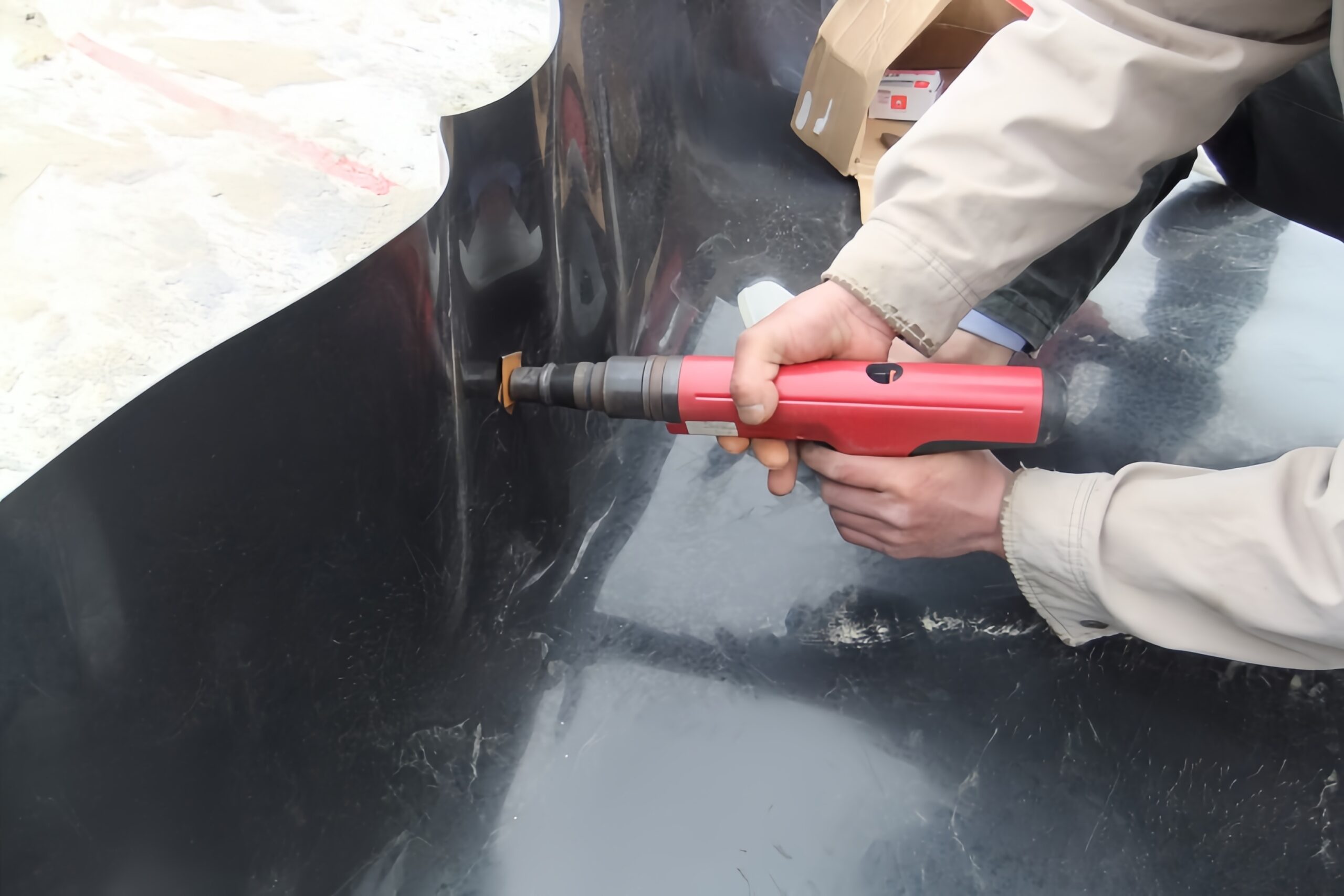 Diagram showing a cross-section of a geomembrane anchor trench at the top of a slope