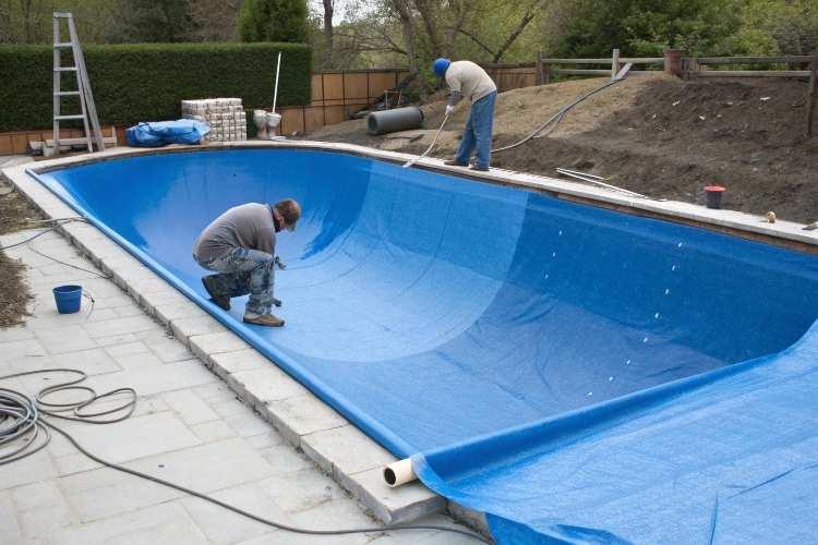 Blue HDPE geomembrane liner expertly installed in a large landscape swimming pool