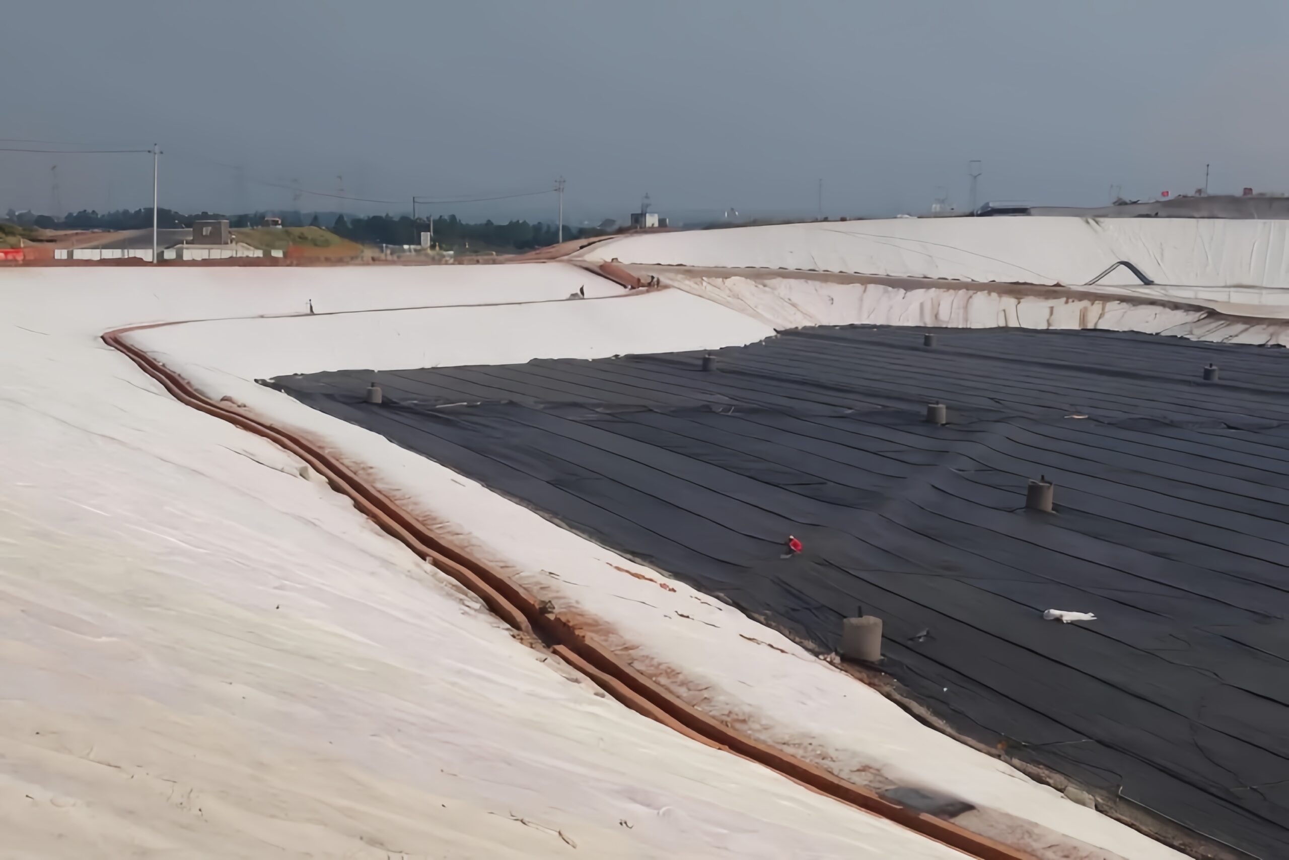 Step-by-step construction sequence of a geomembrane anchor trench from excavation to backfilling