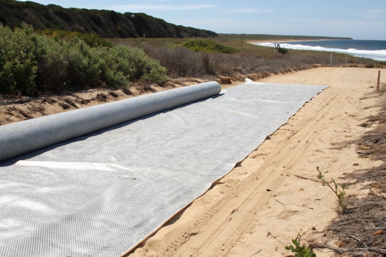 A degraded geotextile crumbling after prolonged sun exposure