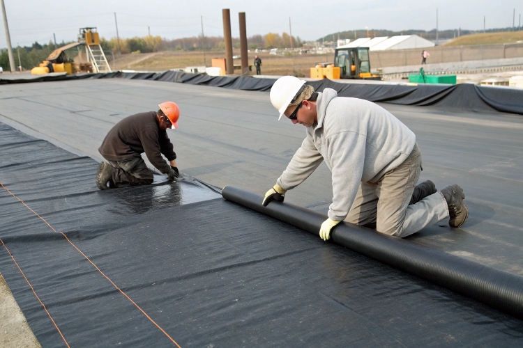 LLDPE geomembrane conforming to the uneven terrain of a containment pond