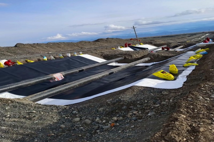 Diagram showing a batten strip, sealant, and anchors used to terminate a geomembrane against a concrete wall
