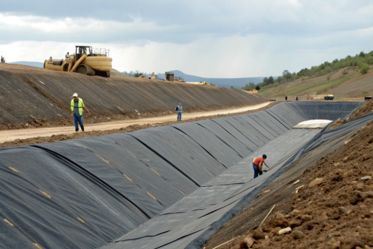 technician performing an air pressure test on an HDPE geomembrane seam weld