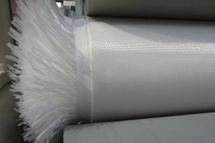 A close-up view showing the interlaced yarn structure of a woven geotextile