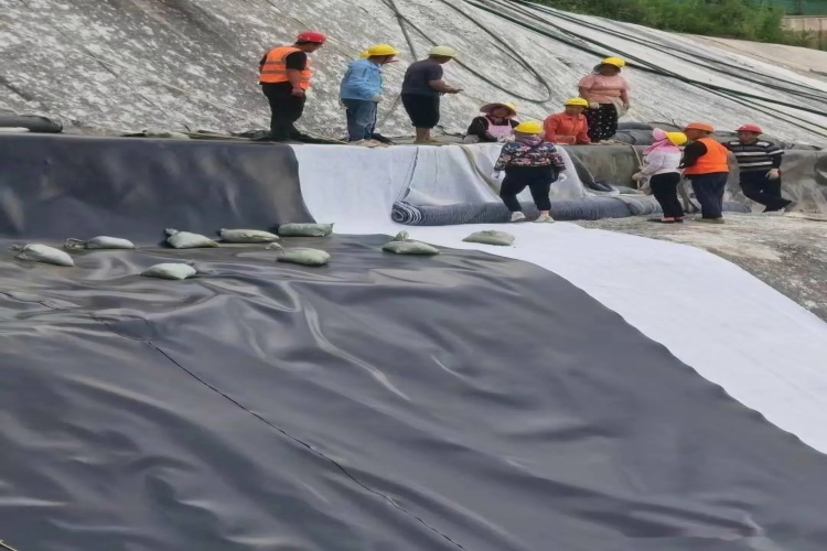 Close-up of a batten strip system showing the layers: concrete, geomembrane, gasket, strip, and bolt