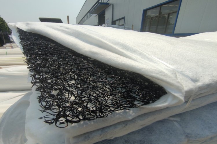 A cross-section view of a drainage geocomposite showing the geonet core and bonded geotextiles