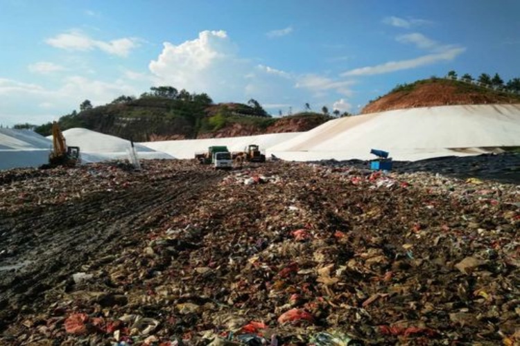 A technician monitoring a flow meter connected to the leak detection system's sump, confirming the system's integrity.