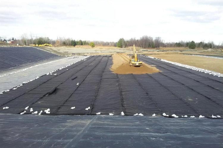 Side-by-side comparison of sandbags vs. a thin layer of soil as temporary cover
