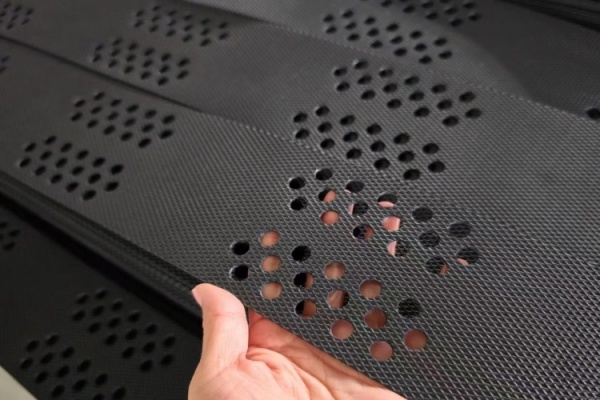 Engineer examining two different geocell samples for quality comparison