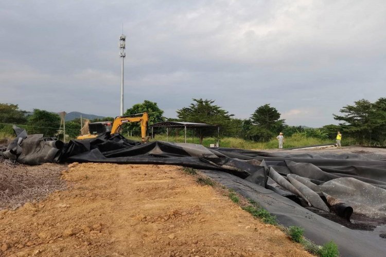An aerial view of a hazardous waste landfill cell under construction, showing the multi-layer liner system