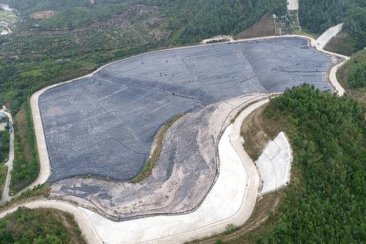A sign at a hazardous waste facility indicating the requirement for a double-liner containment system.