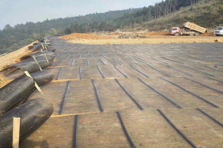 A roll of high-strength uniaxial geogrid ready for installation in a landfill