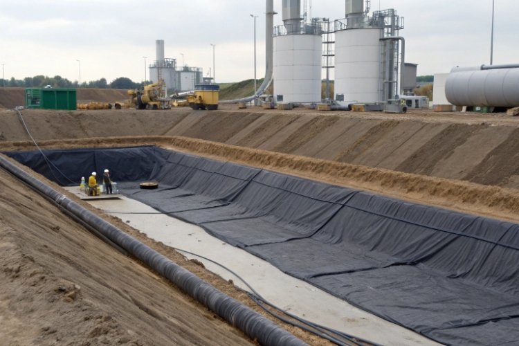 Diagram of a double-liner system with a geonet leak detection layer and a sump for monitoring