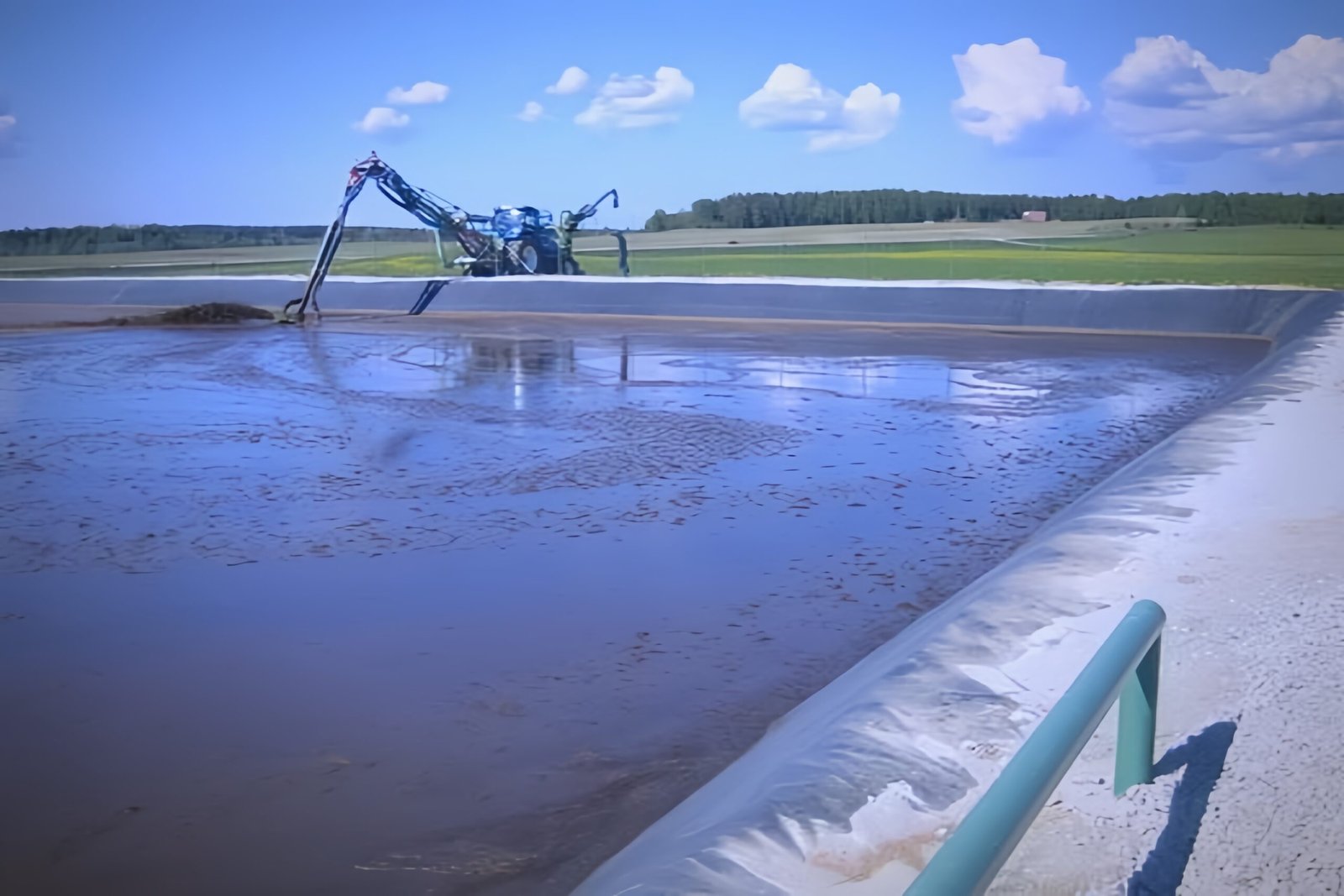 An aerial view of a complete biogas facility, showing anaerobic digesters, storage lagoons, and processing buildings.