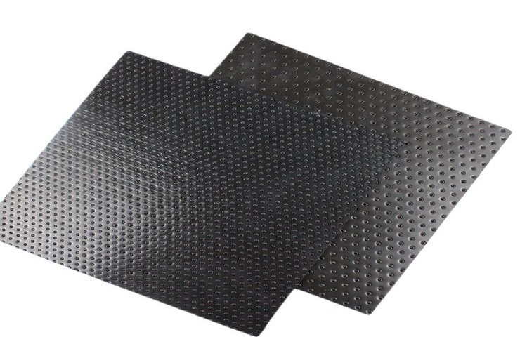 Installation of a textured geomembrane on the steep slope of a tailings storage facility dam.