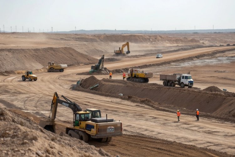 Heap leach pad construction site with heavy machinery