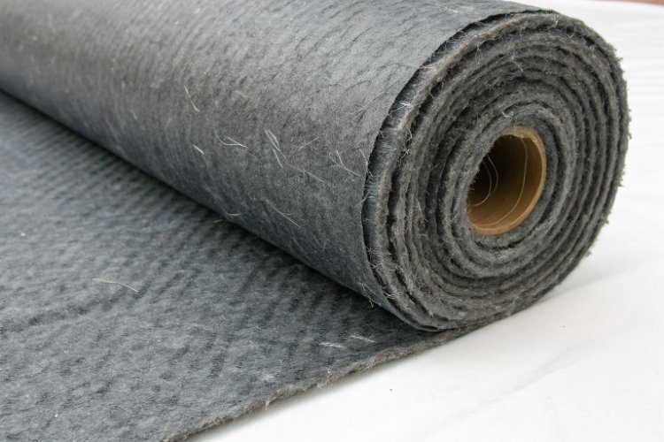 A close-up shot showing the thick, fibrous texture of a heavy-weight nonwoven polypropylene geotextile.