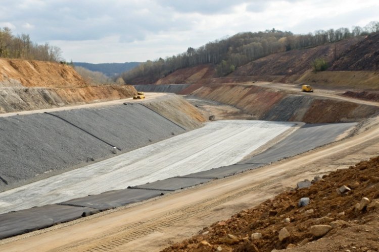 A cross-section diagram of a heap leach pad illustrating the zone-based selection of smooth geomembrane on the base and textured geomembrane on the slopes.