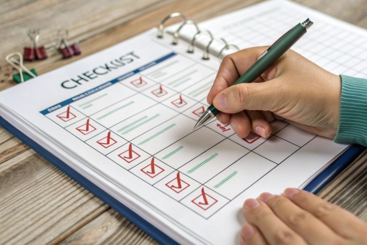 Checking Geomembrane Parameters Technician holding a caliper measuring the thickness of a black geomembrane sheet