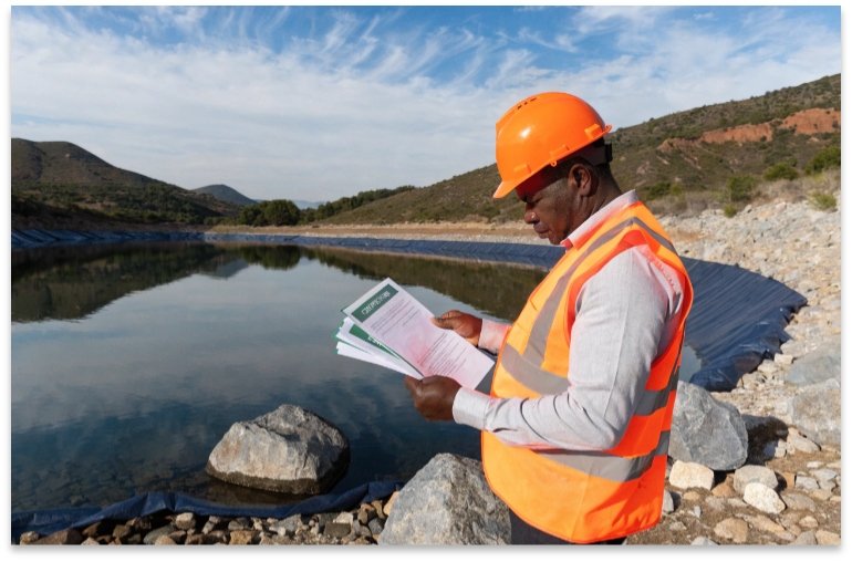 Engineer checking certification documents for water reservoir liner