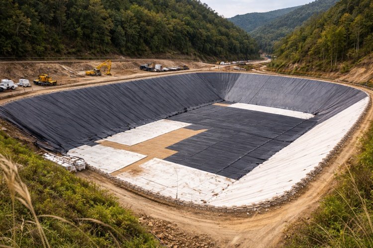 Installing a heavy-duty geomembrane over a geotextile protection layer